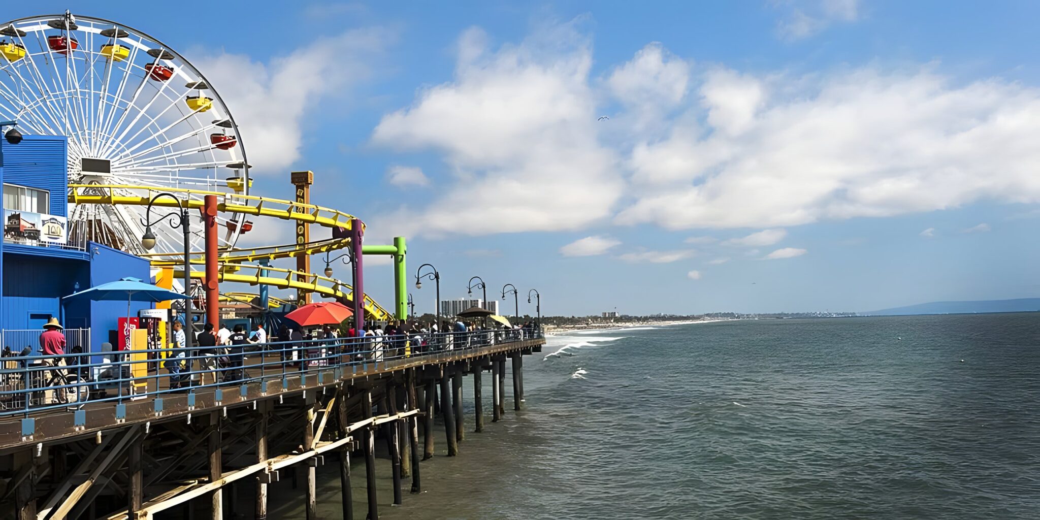 Santa Monica Pier with the ferris wheel and amusement rides beside the ocean