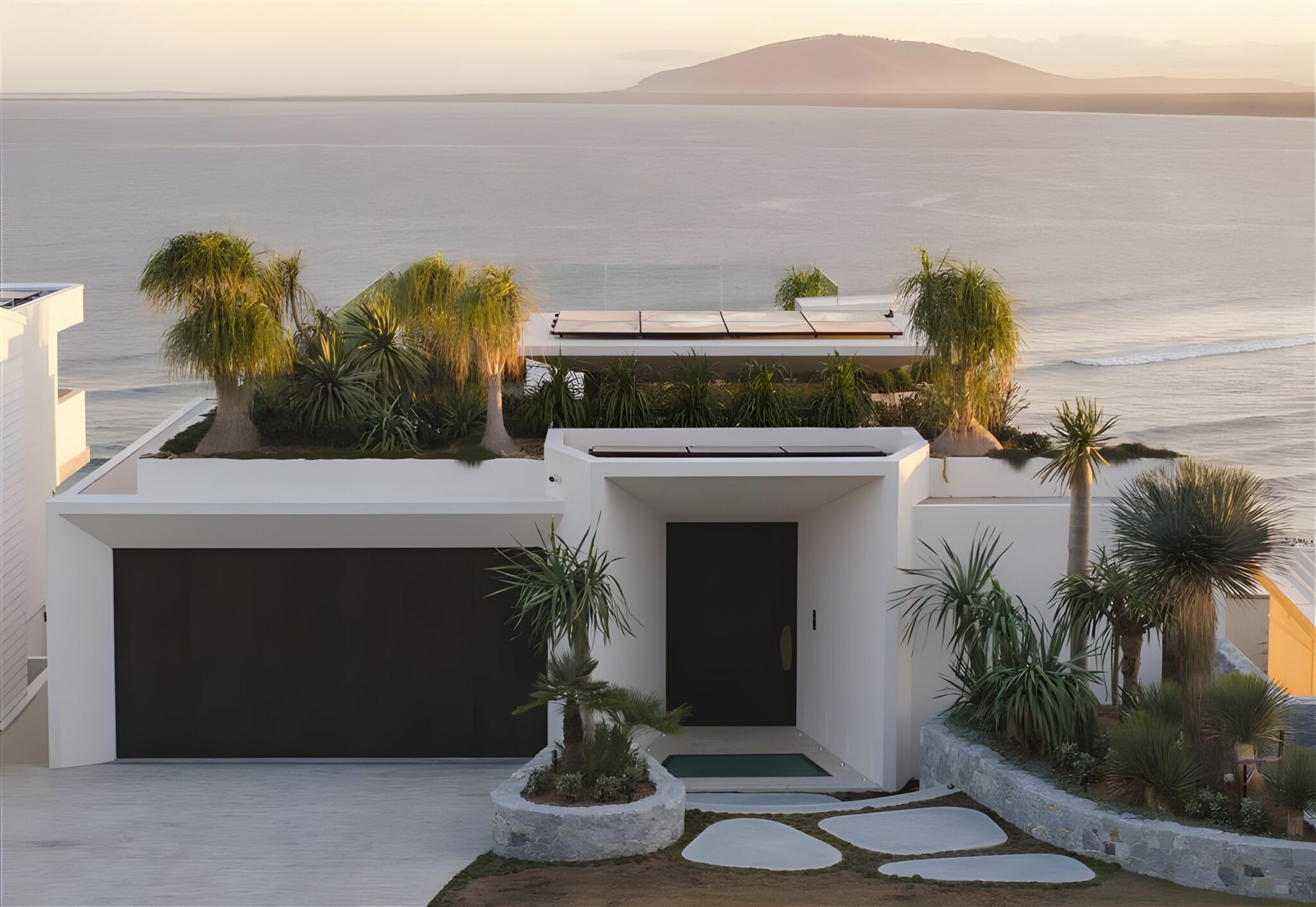 The Solstice by Futureflip at golden hour, a white coastal home with a planted roof terrace above Seven Mile Beach on the NSW South Coast