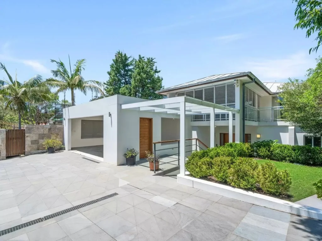 Contemporary white harbourside home with pergola entry and gardens in Watsons Bay
