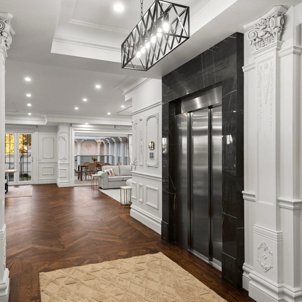 Balwyn luxury home entrance with centerpiece black marble framed stainless steel lift