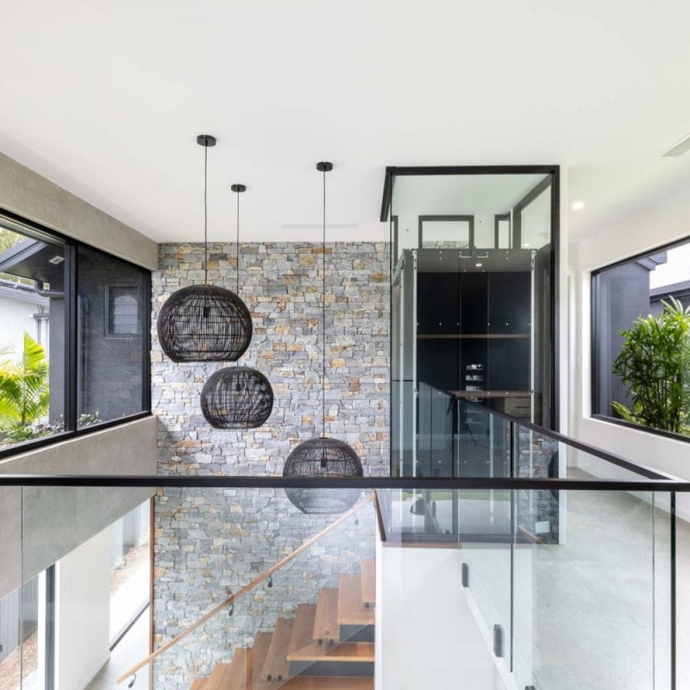 Black wing door of A Series lift as architectural feature