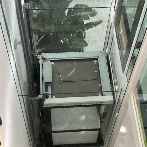 Lift Shop A Series glass elevator in The Solstice, connecting three levels with frameless doors.