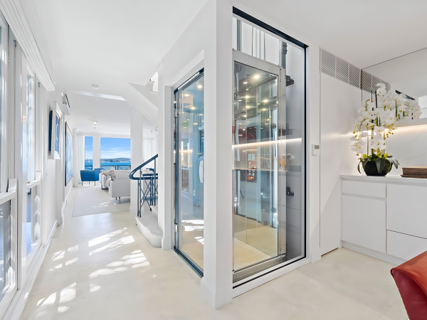 Steel and glass lift shaft constructed by builder for architectural home interior